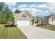 View of a single story brick house with attached two car garage and a driveway on a sunny day at 3382 Long Creek Dr, Buford, GA 30519