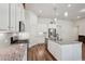 Modern kitchen features granite countertops, stainless steel appliances, a center island, and easy access to living spaces at 3382 Long Creek Dr, Buford, GA 30519