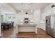Bright kitchen featuring granite countertops, stainless steel appliances, and an island with pendant lighting at 3382 Long Creek Dr, Buford, GA 30519