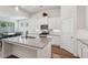 Well-lit kitchen with an island, stainless steel appliances, granite countertops, and an adjacent dining area at 3382 Long Creek Dr, Buford, GA 30519