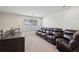 Comfortable living room with large leather seating and a bright window for natural light at 3382 Long Creek Dr, Buford, GA 30519