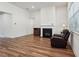 Cozy living room featuring a fireplace, neutral walls, and sleek wood flooring at 3382 Long Creek Dr, Buford, GA 30519