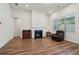 Bright living room featuring a fireplace, neutral walls, and sleek wood flooring at 3382 Long Creek Dr, Buford, GA 30519