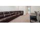 Cozy living room featuring a large, comfortable, dark brown leather sectional sofa with beige carpet at 3382 Long Creek Dr, Buford, GA 30519