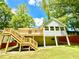 Large backyard features a well-manicured lawn and deck at 8399 Lake Dr, Snellville, GA 30039