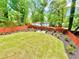 Large backyard with lush green lawn, privacy fence and landscape at 8399 Lake Dr, Snellville, GA 30039