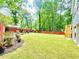 Large backyard with lush green lawn, privacy fence and landscape at 8399 Lake Dr, Snellville, GA 30039