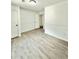 Neutral bedroom featuring hardwood floors, two closets, and wainscoting at 8399 Lake Dr, Snellville, GA 30039