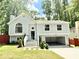 Charming split-level home with a two-car garage, well-manicured lawn, and beautiful, light-blue siding at 8399 Lake Dr, Snellville, GA 30039