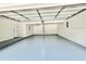 Spacious garage with painted floor, perfect for parking vehicles or storage at 8399 Lake Dr, Snellville, GA 30039