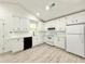Bright and open kitchen featuring stainless steel appliances and an abundance of cabinetry at 8399 Lake Dr, Snellville, GA 30039
