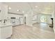 Bright kitchen with stainless steel appliances, white cabinets, an adjacent dining space, and stylish lighting at 8399 Lake Dr, Snellville, GA 30039