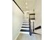 Bright and welcoming stairway with hardwood floors and a neutral color palette at 8399 Lake Dr, Snellville, GA 30039