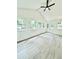 Bright sunroom with many windows, vaulted ceiling, and gray vinyl plank flooring at 8399 Lake Dr, Snellville, GA 30039