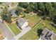 The aerial shot highlights a spacious layout with ample parking, a well-manicured lawn, and a playground at 13 Four Feathers Ln, Rydal, GA 30171