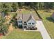 An aerial view of the property reveals a spacious yard, a long driveway, and ample privacy surrounded by trees at 13 Four Feathers Ln, Rydal, GA 30171