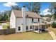 Back view showing the patio with outdoor seating, a well-maintained yard, and partial privacy fence at 13 Four Feathers Ln, Rydal, GA 30171