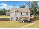 Rear of the home showing a cozy patio and large yard, perfect for outdoor entertaining and relaxation at 13 Four Feathers Ln, Rydal, GA 30171