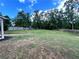 Large backyard features a wooden fence, mature trees, and green space for activities at 13 Four Feathers Ln, Rydal, GA 30171