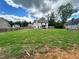 Spacious backyard with lush green grass, fence and view of the rear of the house at 13 Four Feathers Ln, Rydal, GA 30171