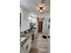 Bright bathroom with double sinks and granite counters; a tiled floor extends to the shower and toilet area at 13 Four Feathers Ln, Rydal, GA 30171