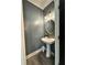 Charming powder room with modern fixtures and elegant pedestal sink at 13 Four Feathers Ln, Rydal, GA 30171