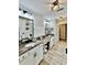 This primary bath includes granite counters, double vanity, wood-look floors, and modern lighting at 13 Four Feathers Ln, Rydal, GA 30171