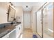 Bathroom featuring granite countertops, double sinks, plank flooring, and a glass shower at 13 Four Feathers Ln, Rydal, GA 30171