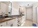 Bathroom with granite countertops, double sinks, white cabinets, plank flooring and a glass shower at 13 Four Feathers Ln, Rydal, GA 30171