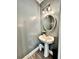 Charming powder room with modern fixtures and elegant pedestal sink at 13 Four Feathers Ln, Rydal, GA 30171