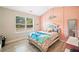Charming pink bedroom with paneling, bright window and cozy bed, perfect for a sanctuary at 13 Four Feathers Ln, Rydal, GA 30171