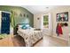 Bright bedroom featuring a dinosaur-themed bed, green accent wall, and natural light from the window at 13 Four Feathers Ln, Rydal, GA 30171