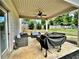 Cozy covered patio featuring an outdoor kitchen area, and lounge area with ceiling fan at 13 Four Feathers Ln, Rydal, GA 30171