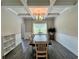 This dining room has great ceiling details, neutral paint, and ample sunlight at 13 Four Feathers Ln, Rydal, GA 30171