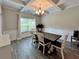 Charming dining room featuring a decorative ceiling, a large window, and a spacious dining table at 13 Four Feathers Ln, Rydal, GA 30171