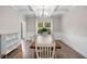Bright dining room with coffered ceilings and a modern light fixture illuminating a rustic dining table setup at 13 Four Feathers Ln, Rydal, GA 30171
