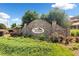 The Foothills at Ridgeland community entrance with stone signage, surrounded by meticulously maintained landscaping at 13 Four Feathers Ln, Rydal, GA 30171