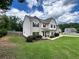 Well-maintained two-story home on a green lawn at 13 Four Feathers Ln, Rydal, GA 30171