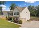 Side view showing a two-car garage and well-kept lawn, highlighting the home's layout and curb appeal at 13 Four Feathers Ln, Rydal, GA 30171