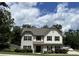 Charming two-story home with a combination of siding and black shutters, plus manicured lawn and landscaping at 13 Four Feathers Ln, Rydal, GA 30171