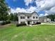 Two-story home with a well-maintained lawn and landscaping at 13 Four Feathers Ln, Rydal, GA 30171
