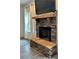 Stone fireplace with wood mantle and mounted television creating a cozy focal point at 13 Four Feathers Ln, Rydal, GA 30171