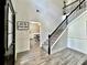 A spacious foyer with a staircase leading to the upper level and a glimpse into the dining area at 13 Four Feathers Ln, Rydal, GA 30171
