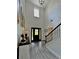 The grand foyer features soaring ceilings, stylish light fixtures, and a staircase with iron balusters at 13 Four Feathers Ln, Rydal, GA 30171