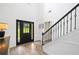 Entryway featuring dark front door and stairs with modern balusters, leading to a bright, welcoming space at 13 Four Feathers Ln, Rydal, GA 30171