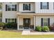Inviting front entrance with a glass-paneled door, stone accents, and well-maintained landscaping at 13 Four Feathers Ln, Rydal, GA 30171