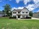 Traditional two-story home with a well-maintained lawn and landscaping at 13 Four Feathers Ln, Rydal, GA 30171