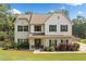 Charming two-story home with a well-manicured lawn and lush landscaping, offering great curb appeal at 13 Four Feathers Ln, Rydal, GA 30171