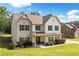 Beautiful two-story home featuring classic architecture and a neatly landscaped front yard on a sunny day at 13 Four Feathers Ln, Rydal, GA 30171