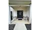 Inviting front porch featuring two rocking chairs and a black front door at 13 Four Feathers Ln, Rydal, GA 30171
